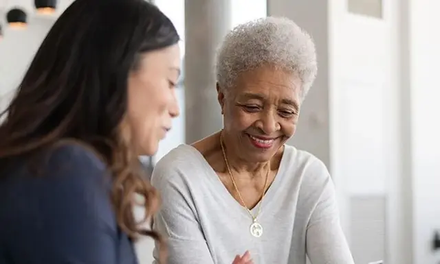 Caregiver supporting senior client during home care session