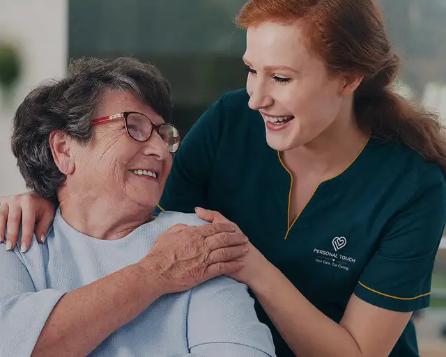 Caregiver smiling with senior client