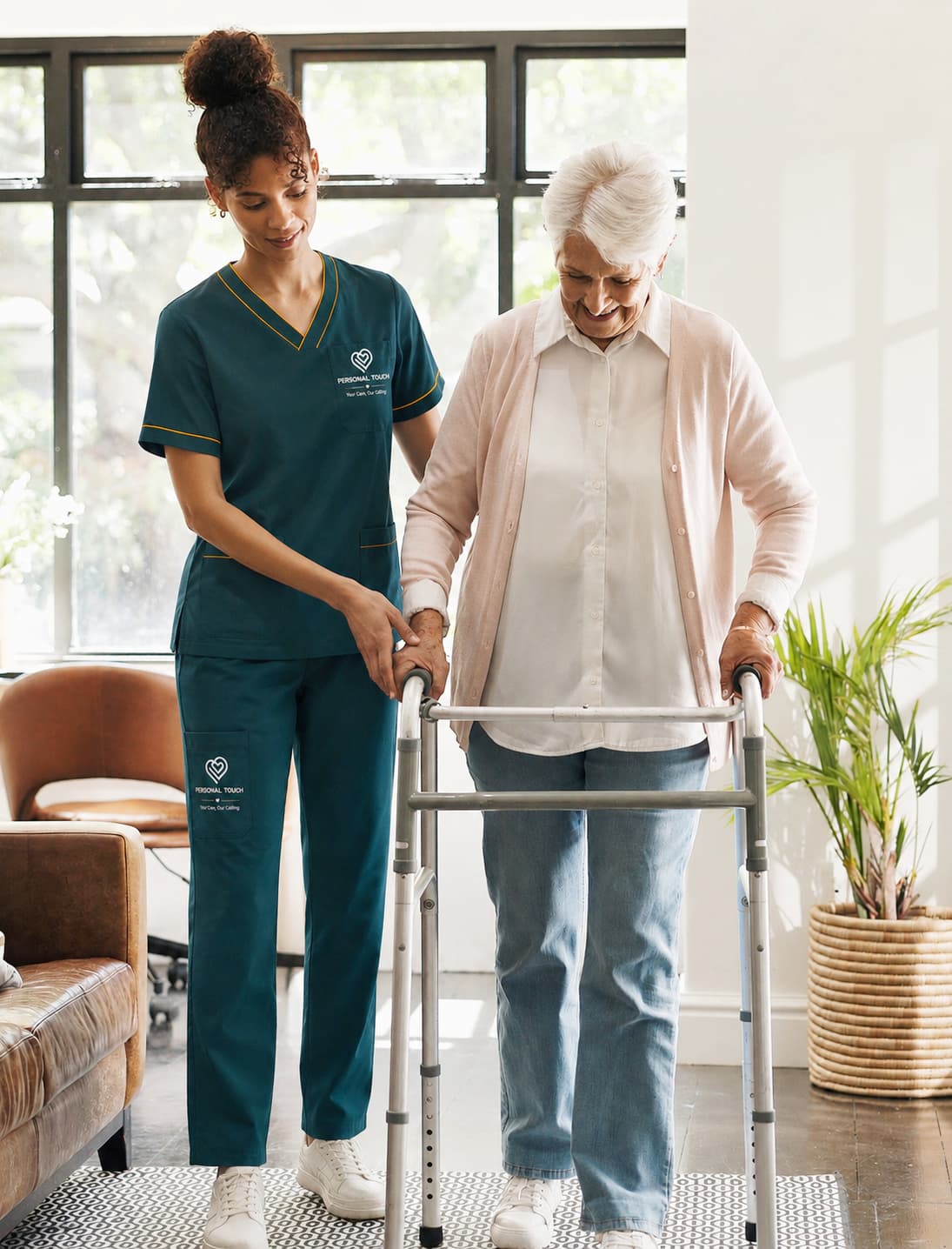 Caregiver assisting elderly woman with walker